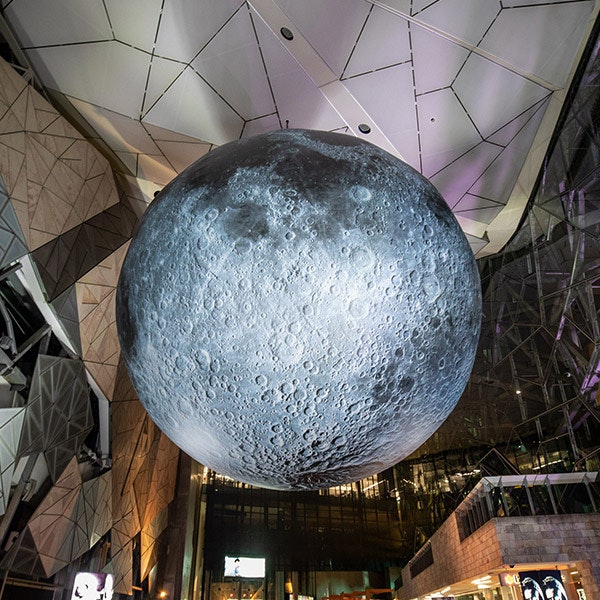 A moon hanging from the Atrium ceiling at Fed Square for Disney's Moon at the Museum installation