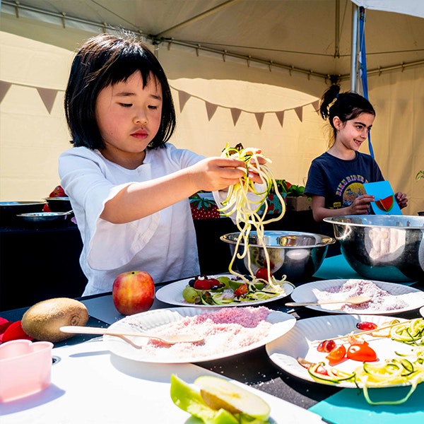 Two kids creatively using food to tell a story at the Little Food Festival