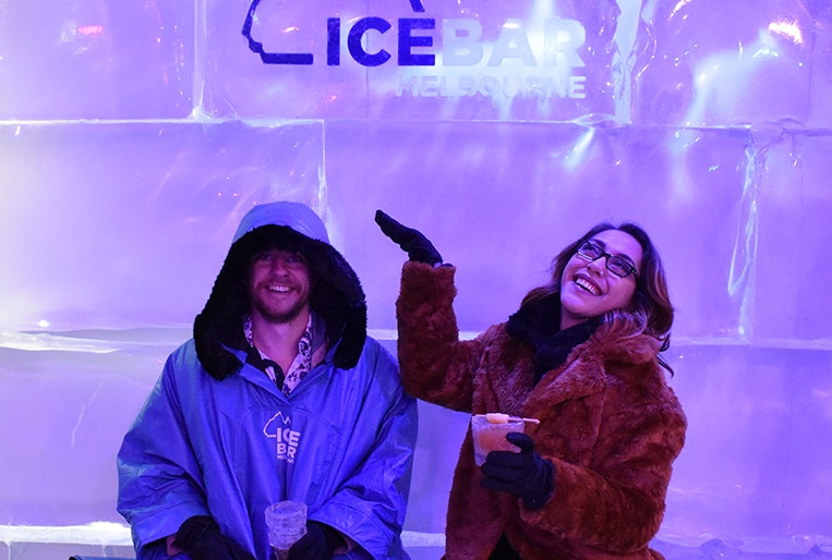 Two people sitting in IceBar smiling at the camera