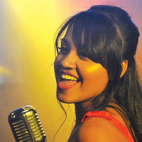 Jessica Mauboy mid song using on 60s style microphone
