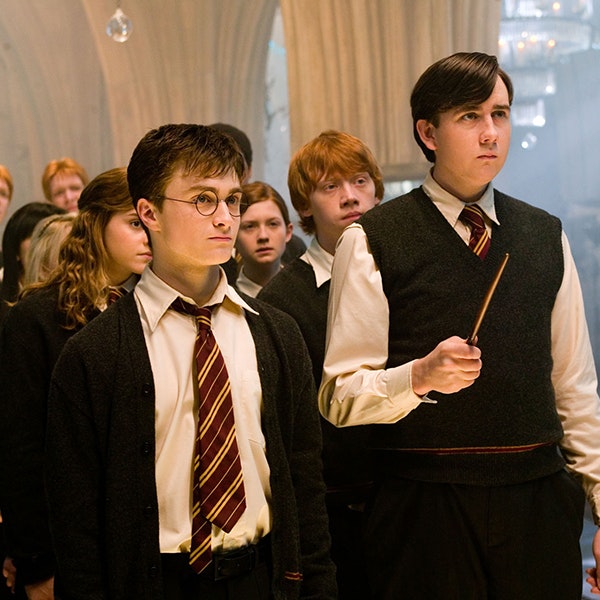 Harry is teaching Neville a spell in the room of requirement for Dumbledore's Army