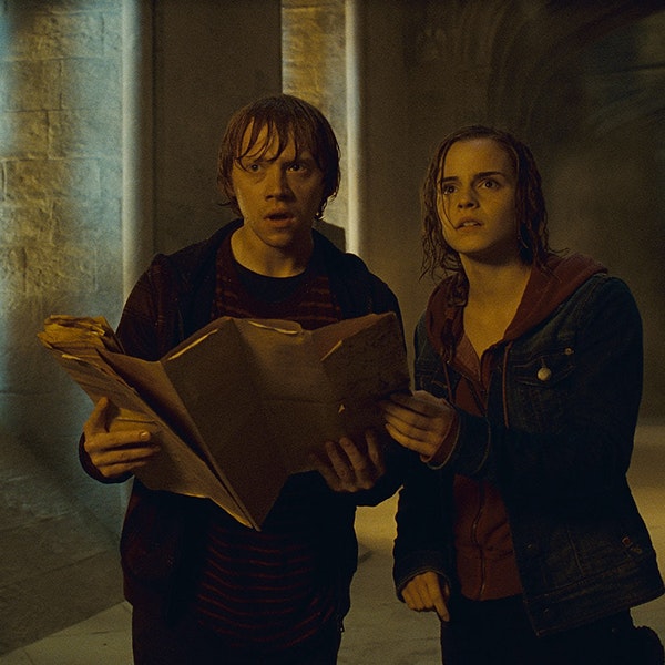 Hermione and Ron holding the Marauder's Map while wet in a Hogwarts hallway