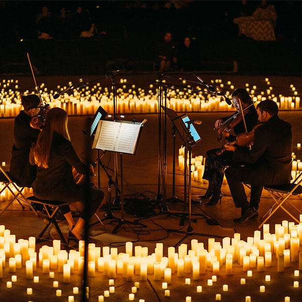 A string quartet playing by candlelight