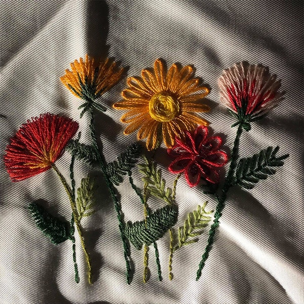 Embroidery of five colourful flowers