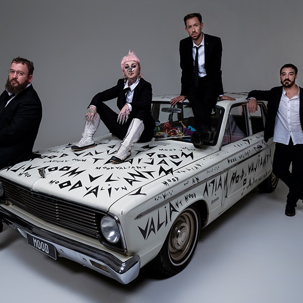 Neo-soul band Hiatus Kaiyote are sitting on a graffitied Valiant car