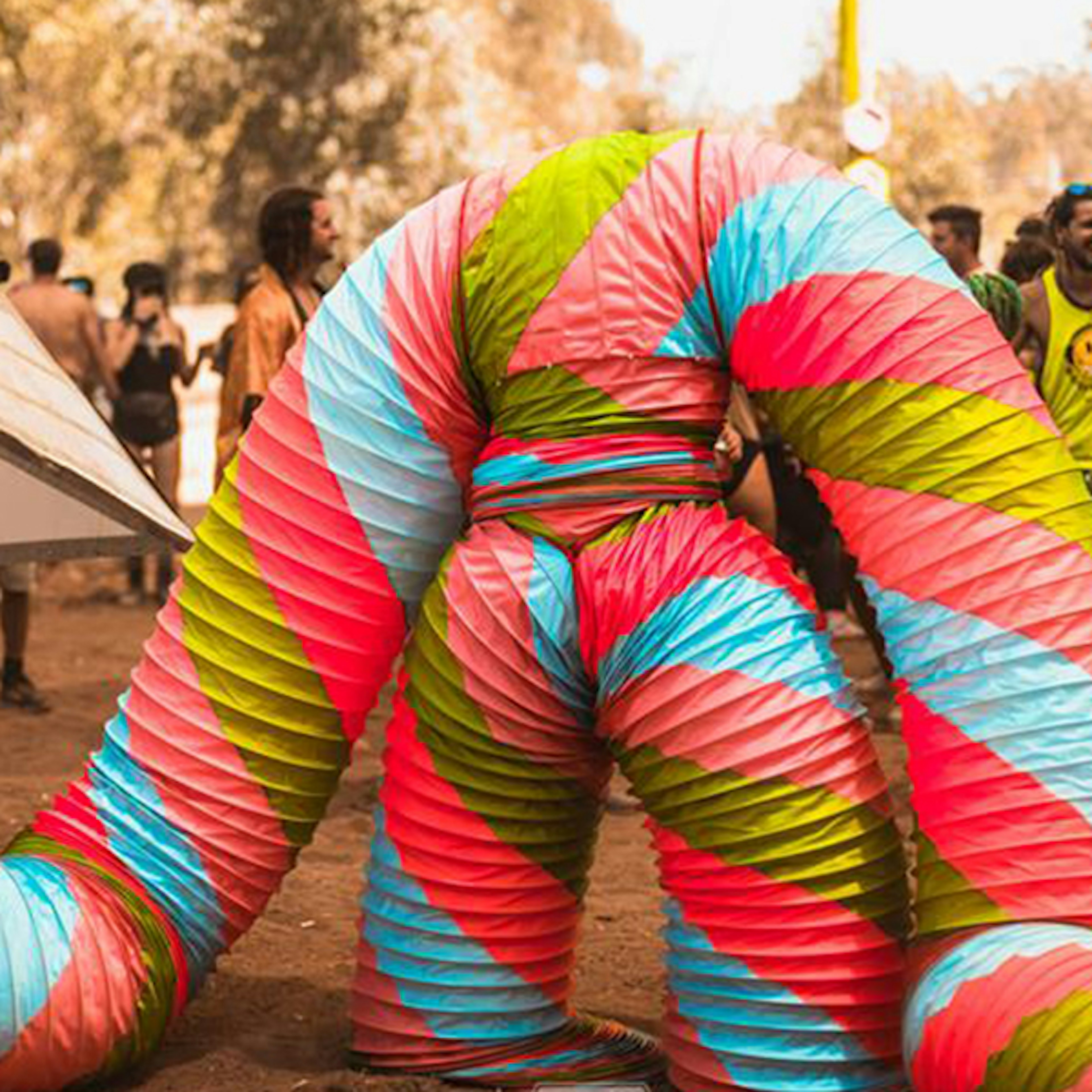 A man dressed in a bulky and multi-coloured slinky suit