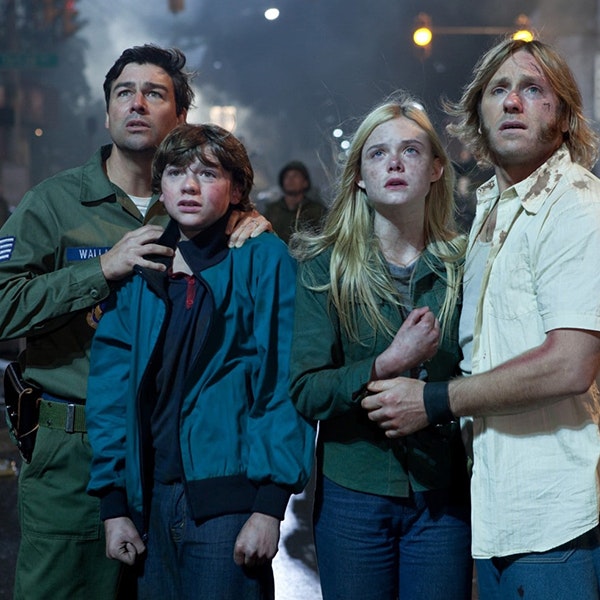 The stars of Super 8 are posing together in a scene with looks of shock on their faces