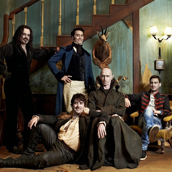 The vampires from What We Do In The Shadows are posing in their house for a photo