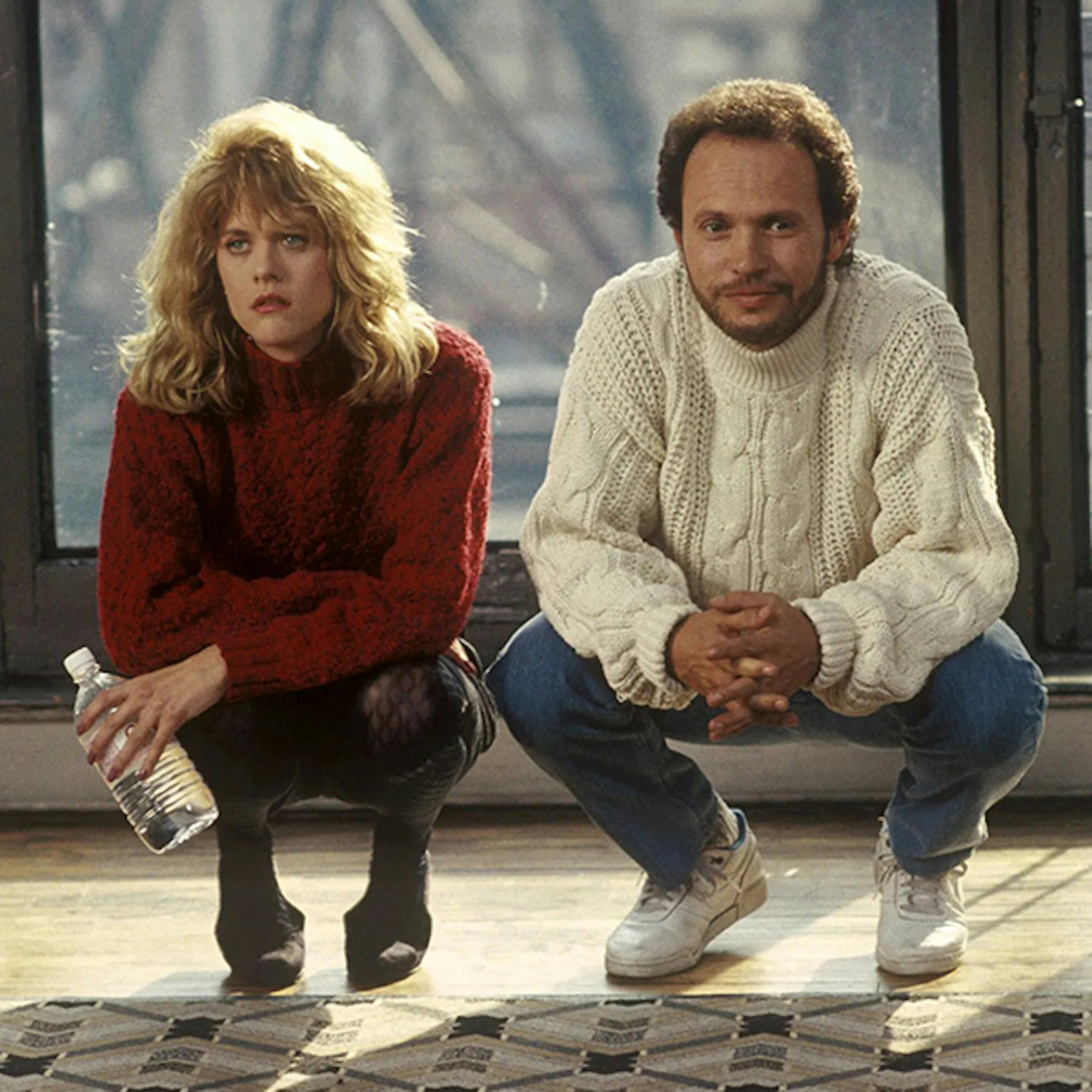 Meg Ryan and Billy Crystal are crouching in an apartment in When Harry Met Sally