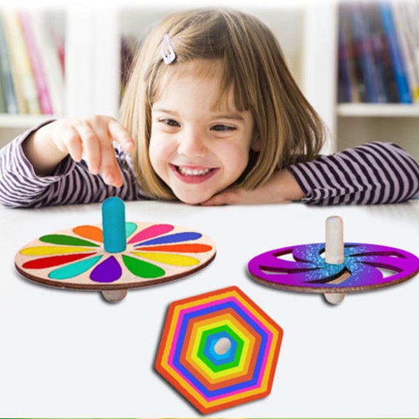 A child playing with colourful fidget spinners for the Fidget Fun Fizz Kidz workshop