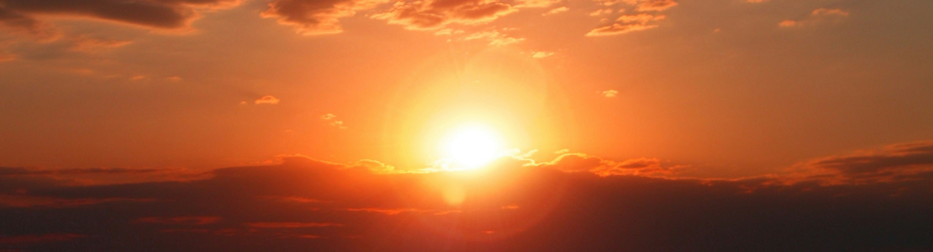 A photo of a sunset through clouds