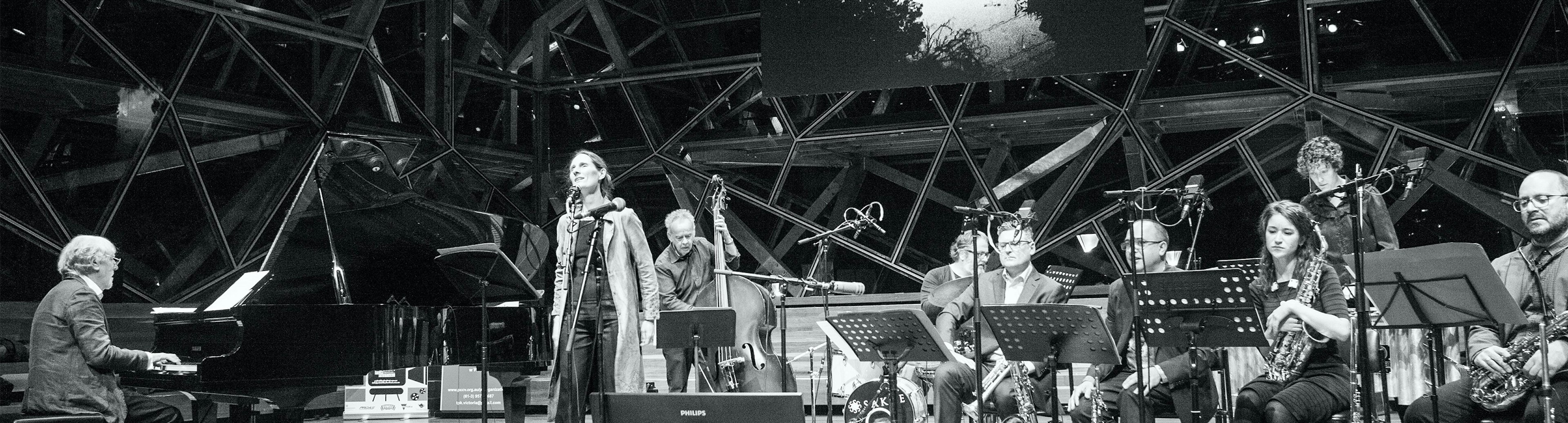 A black and white photo of Adam Simmons jazz band in The Edge at Fed Square
