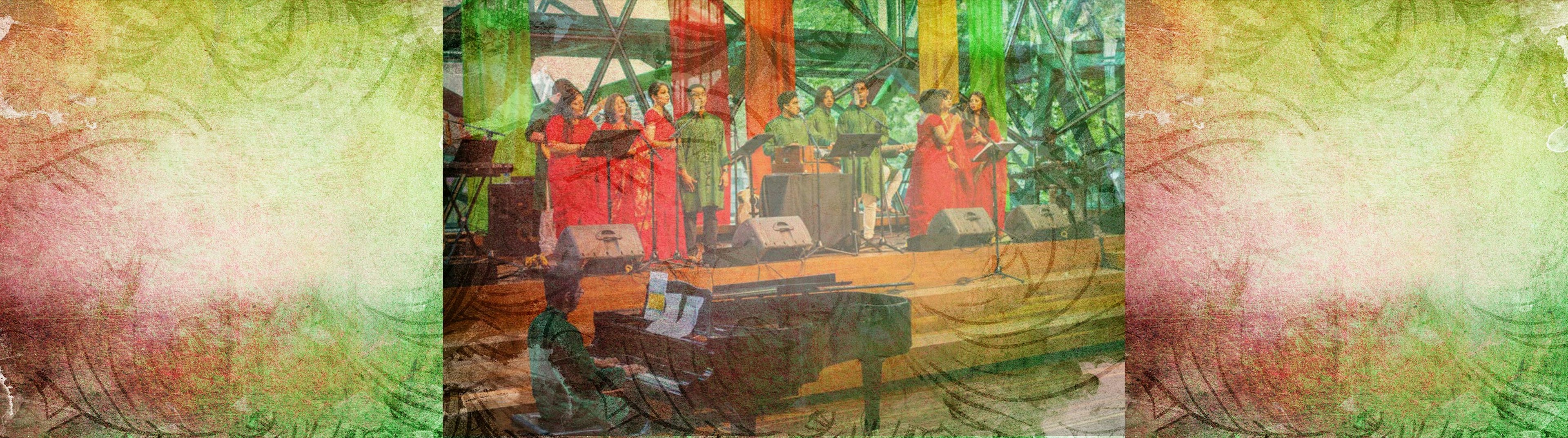 Bangladesh performers on stage at Fed Square, women are wearing red and men are wearing green, there is a grand piano being played in the foreground