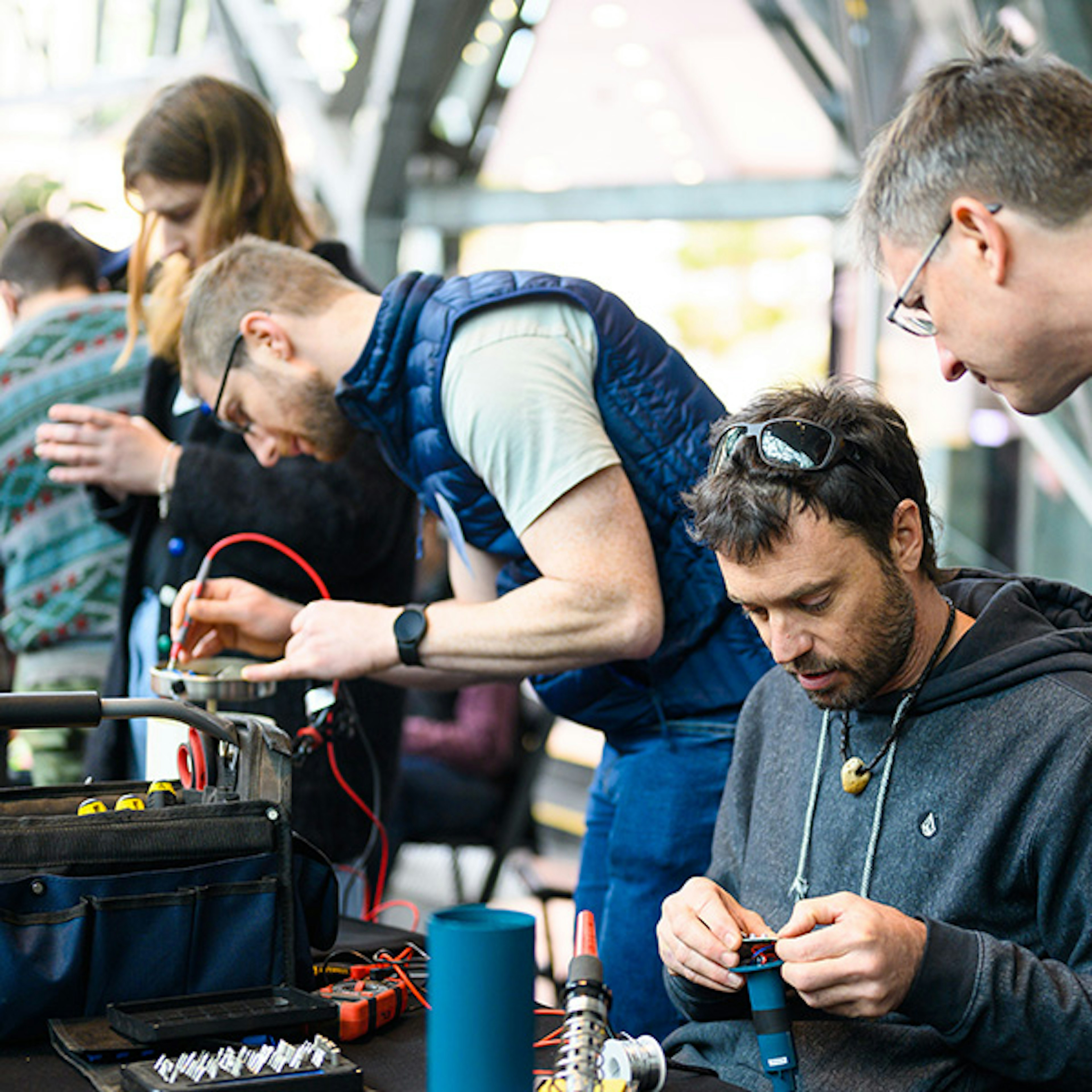 People are using soldering irons at Fed Square to fix household electronics