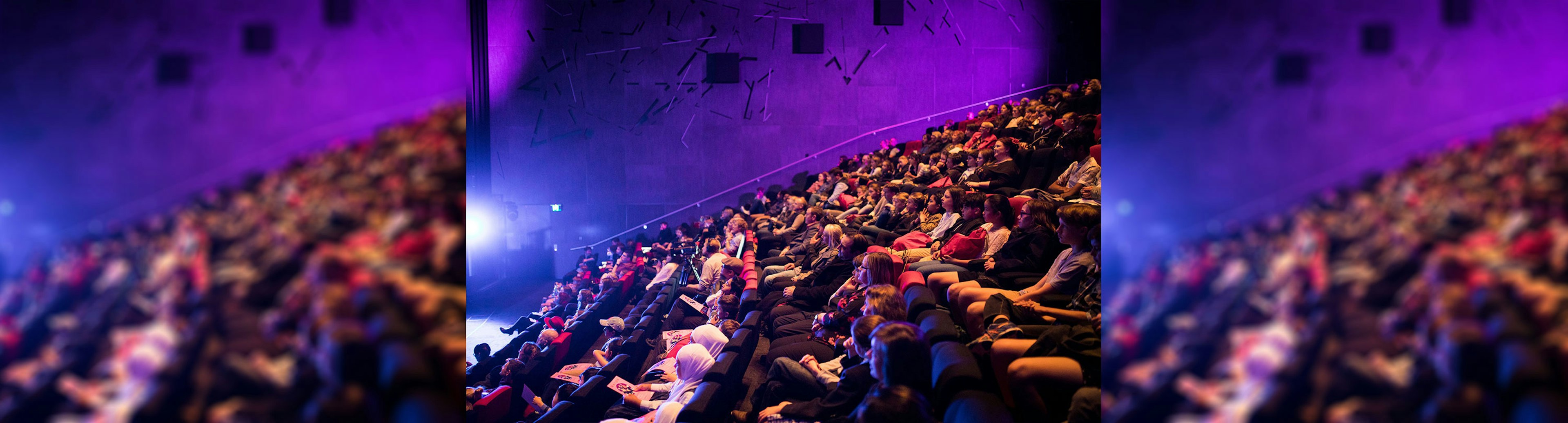 A crowd of people sitting in the cinema at ACMI