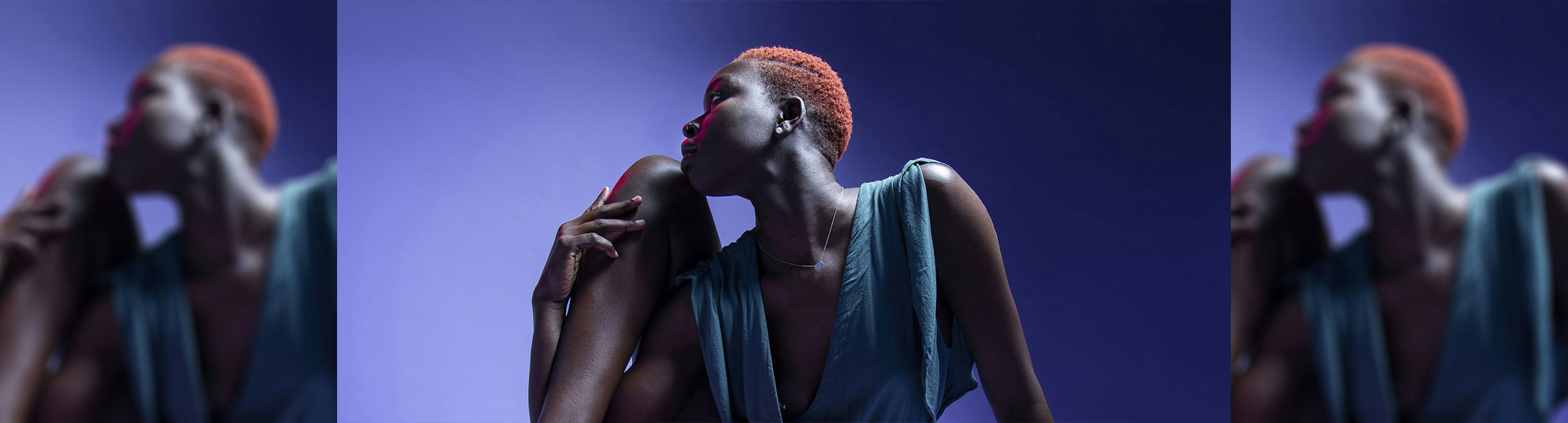 A profile shot of musician POOKIE facing to the left with a purple background behind her