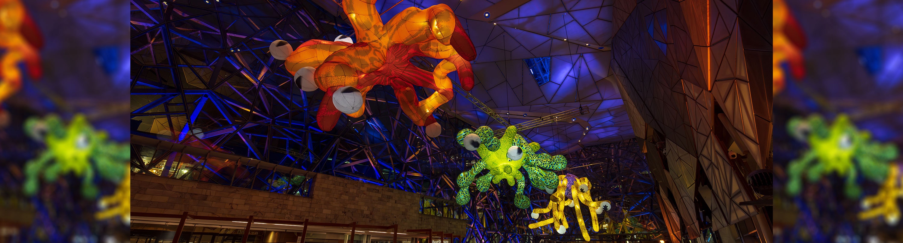 Colourful inflatable underwater sea creatures are hung from the roof of the Atrium
