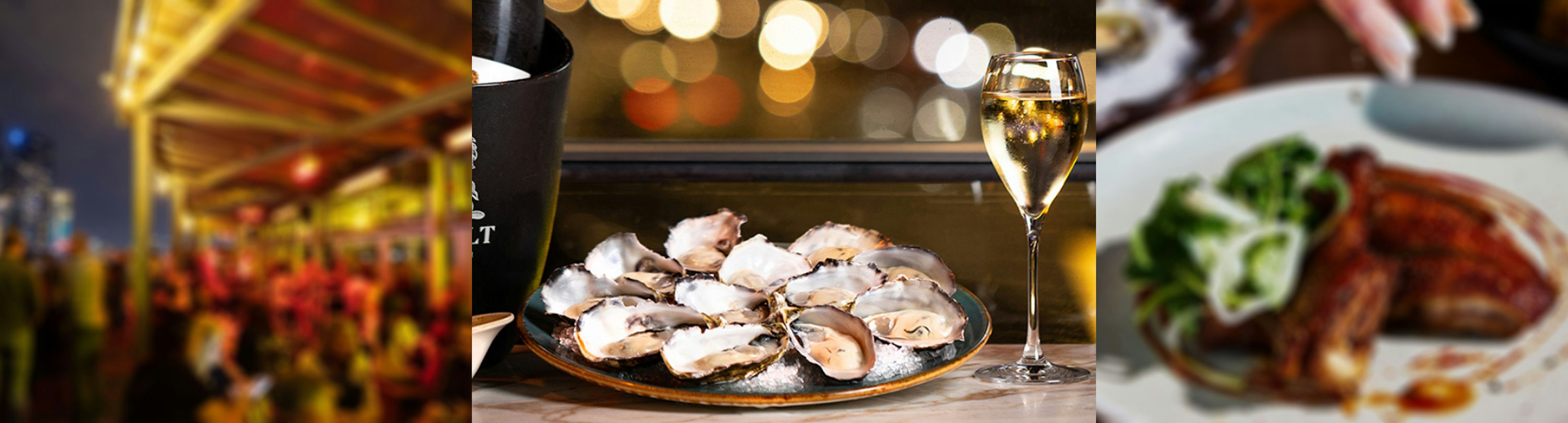 A dozen fresh oysters sitting on a plate next to a glass of champagne