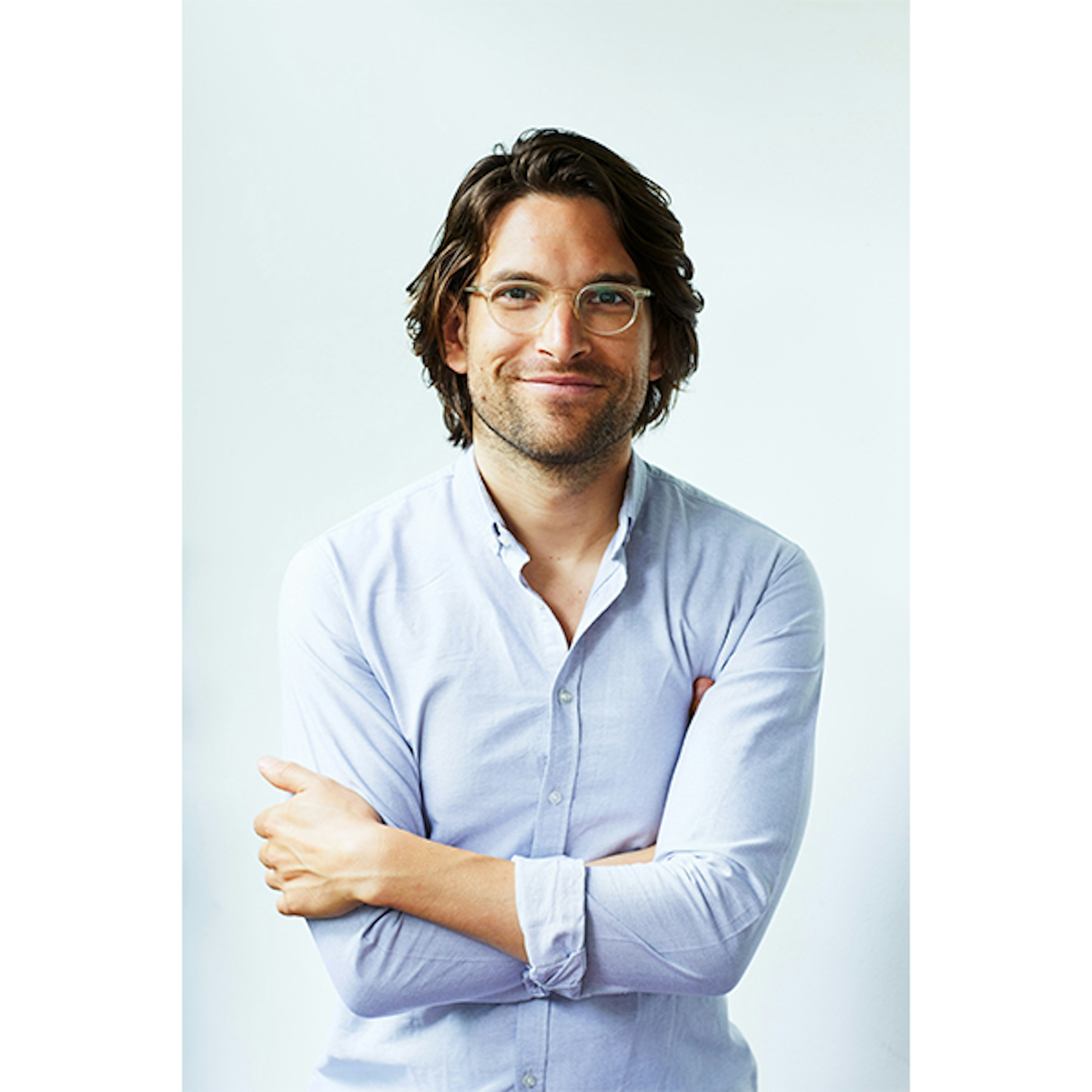 A head shot of VicHealth CEO Dr Sandro Demaio wearing a light blue shirt smiling at the camera