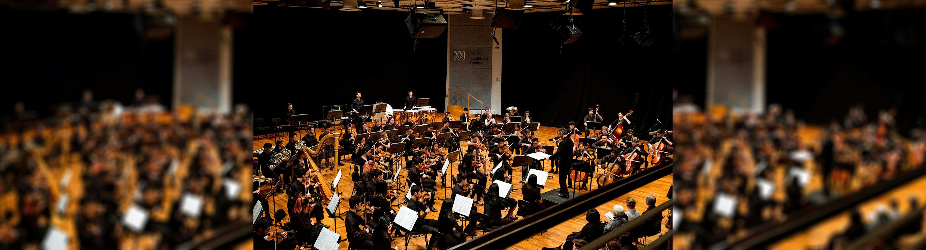 An orchestra is performing on stage