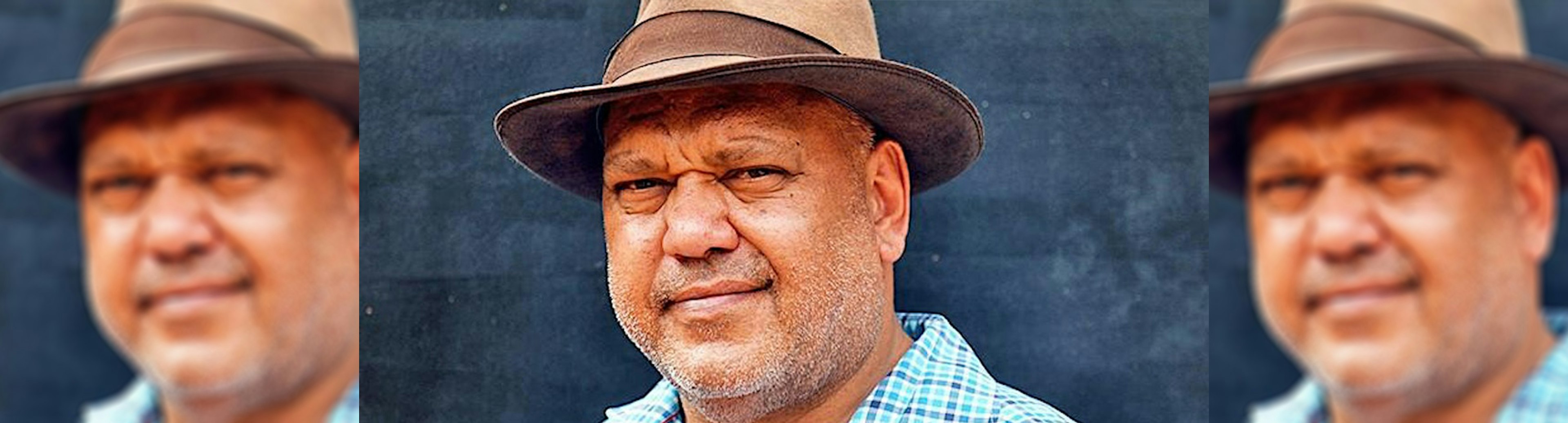 A headshot of Noel Pearson where he is looking directly into the camera and is wearing a brown fedora like hat