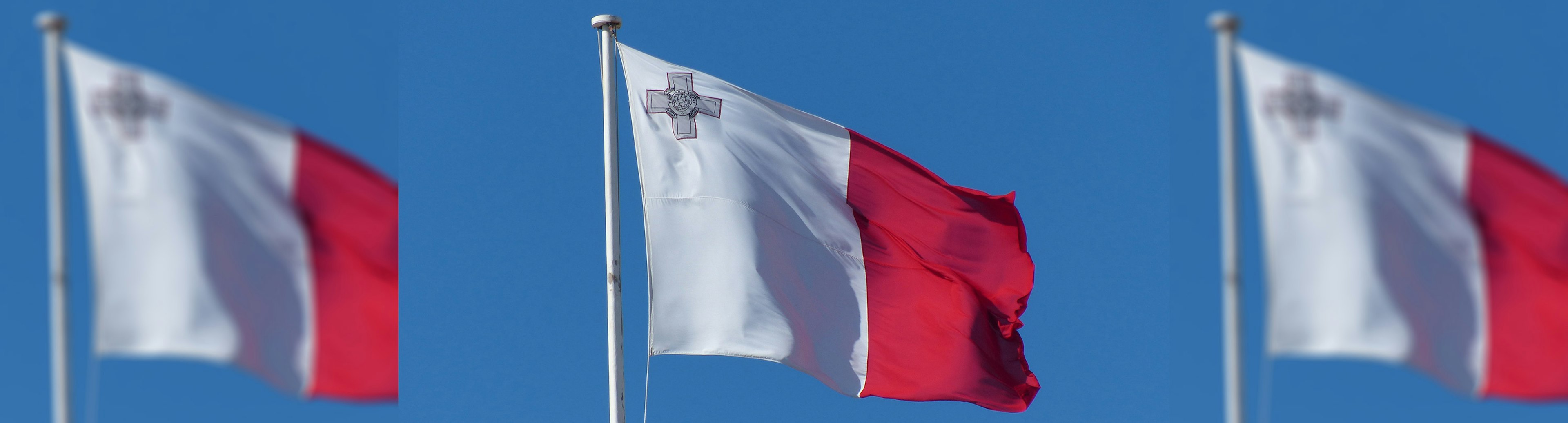 The Maltese flag flying in the sky