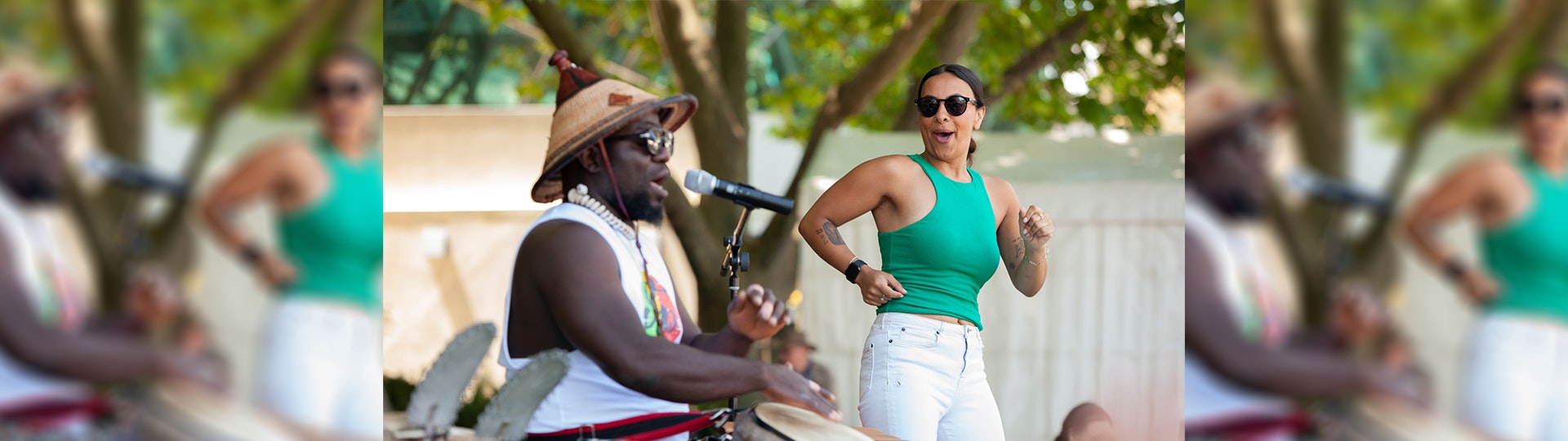 A woman dancing next to an African drummer