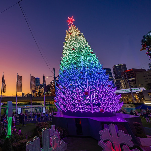 An LED Christmas Tree lit up in rainbow colours at Fed Square