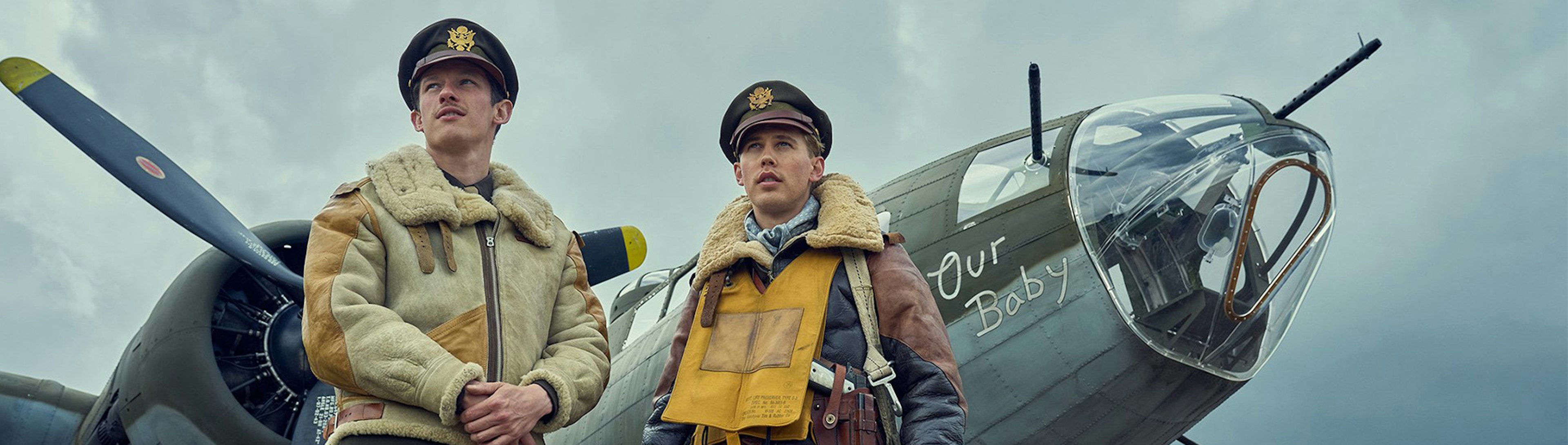 Two American World War 2 fighter pilots standing in front of a an aeroplane from that era