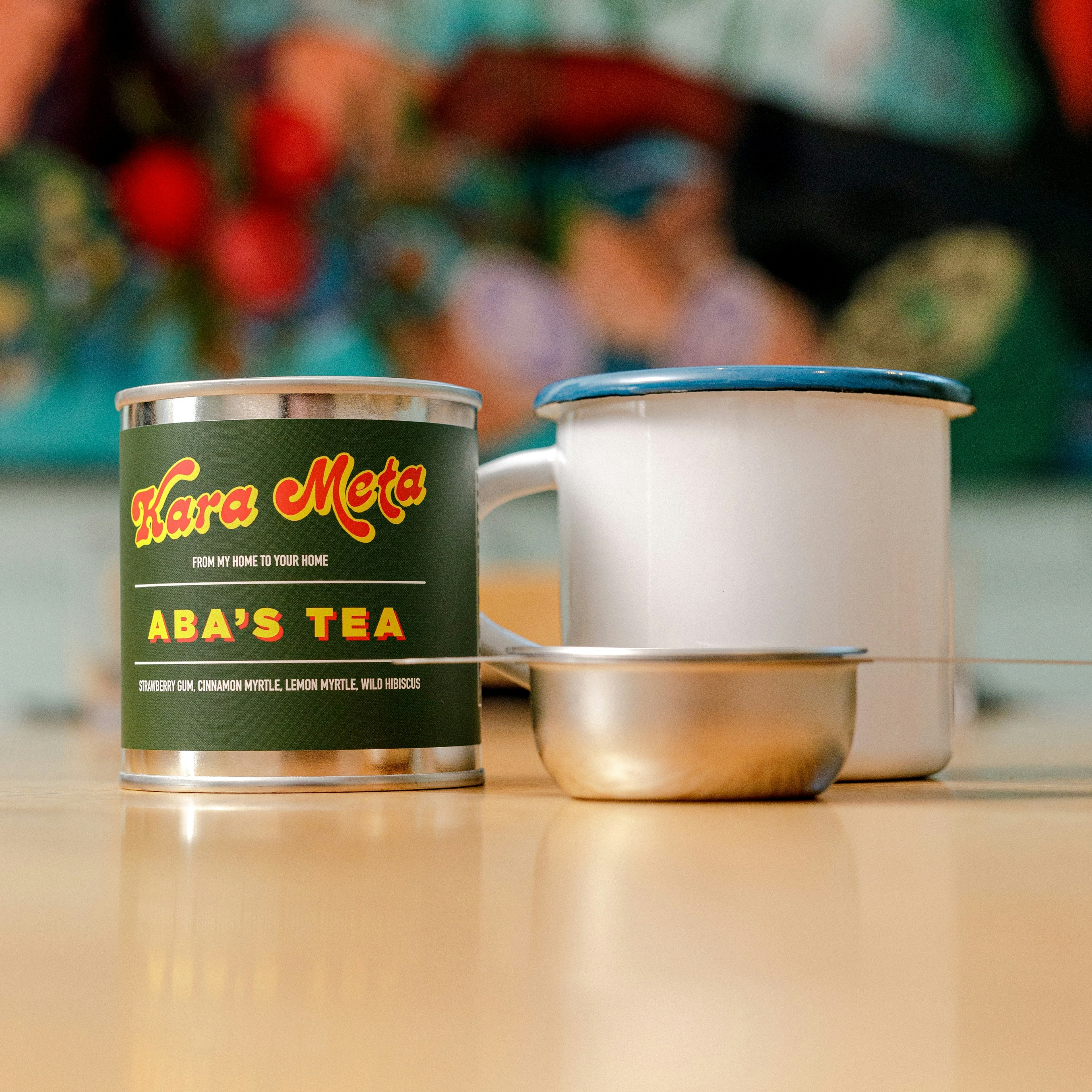 A green tin reads 'Kera Mata' and 'Aba's Tea', next to a white mug