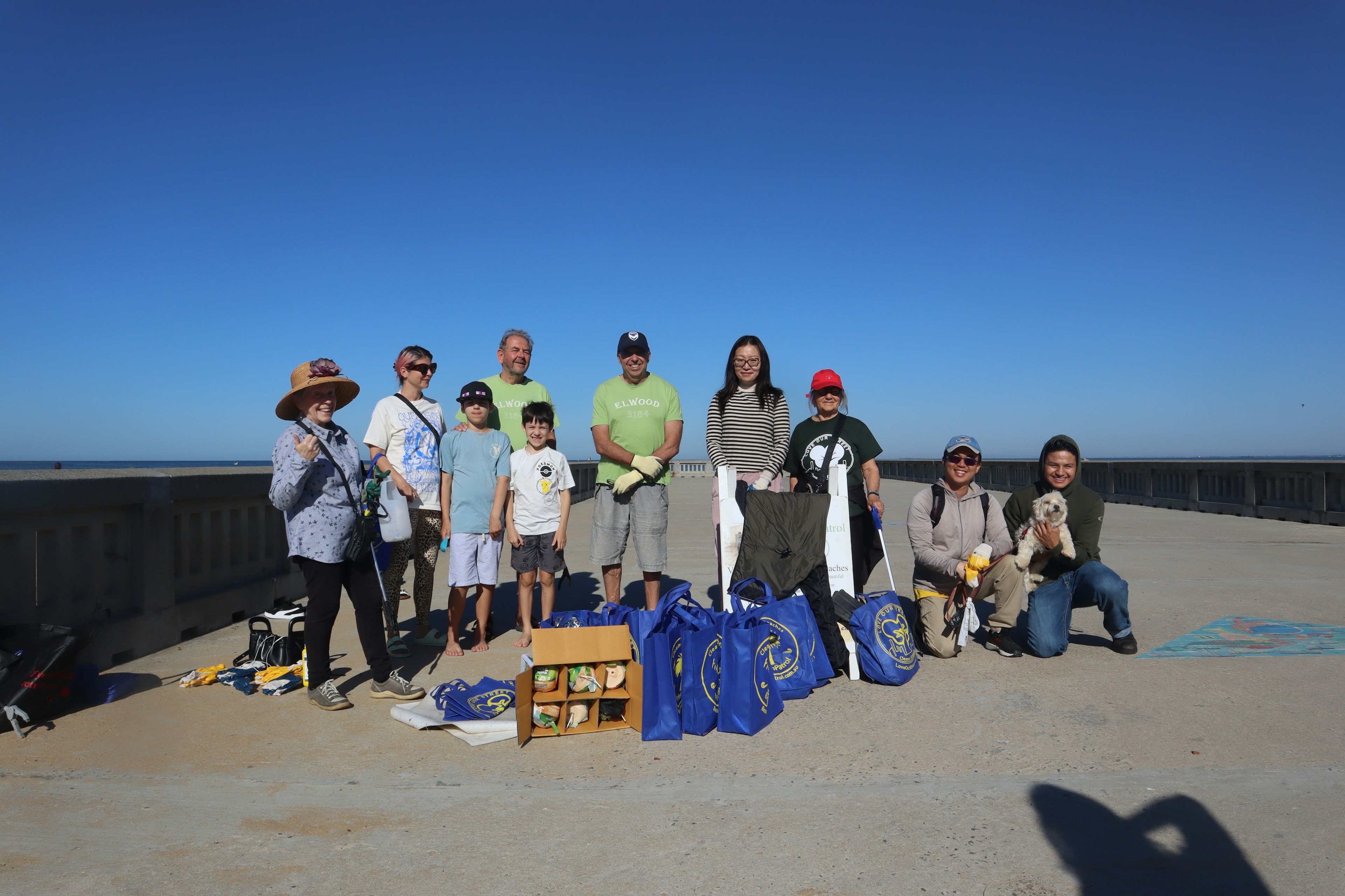 people on a beach, with litter they have collected.