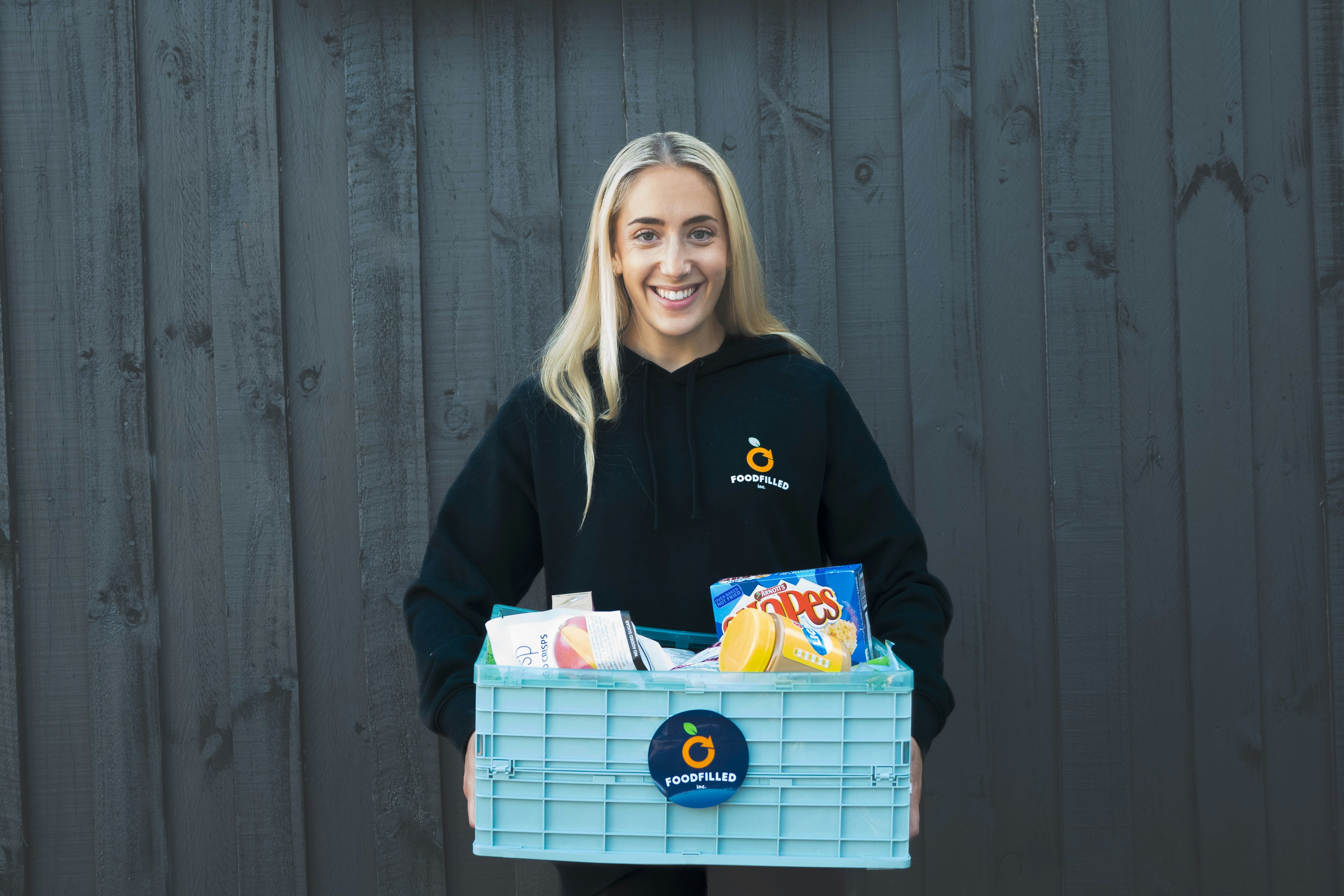 Belle Goldman, CEO of Foodfilled, holds a box of rescued food.