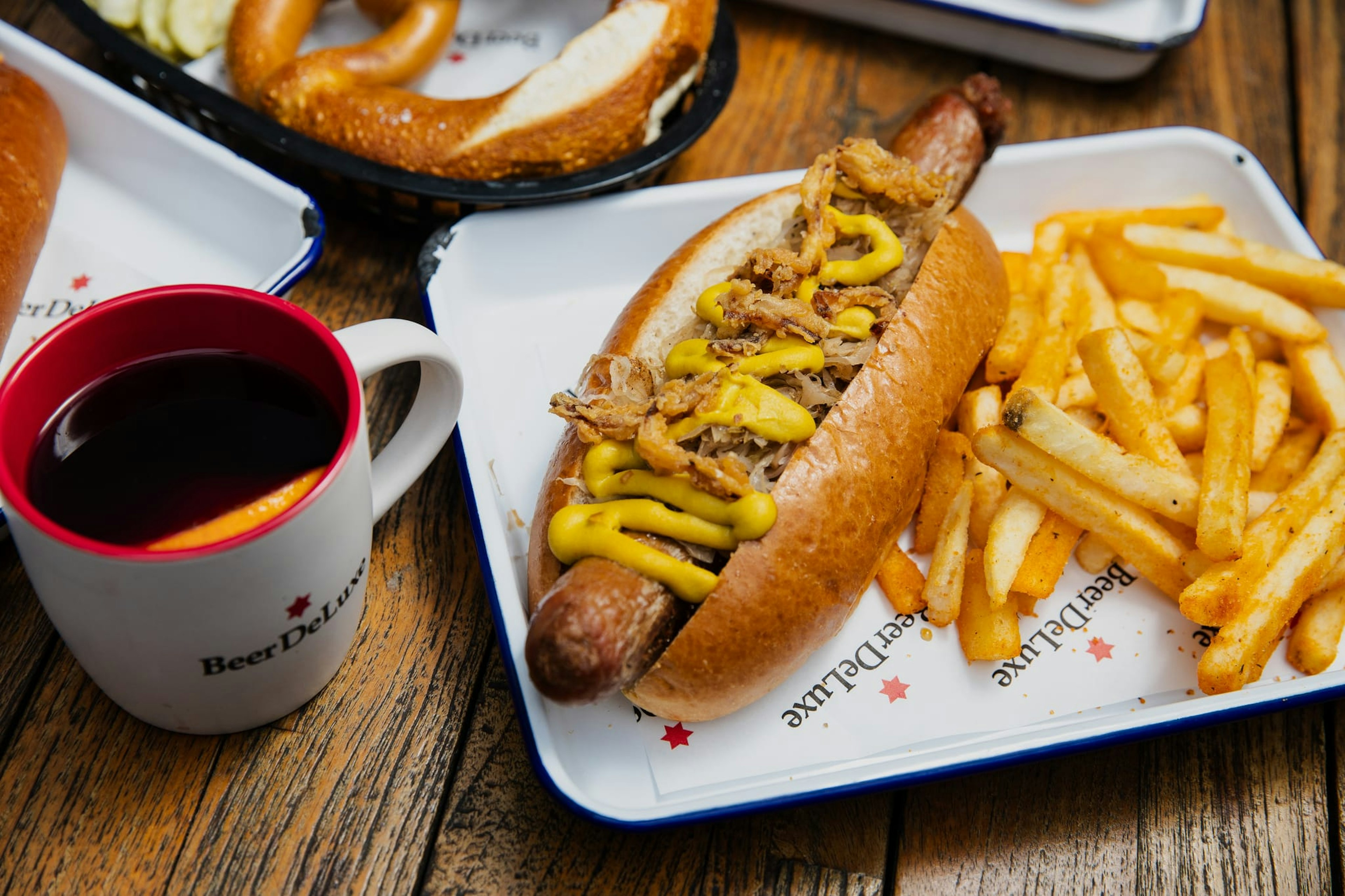 A hot dog with chips and a mulled wine at Beer Deluxe